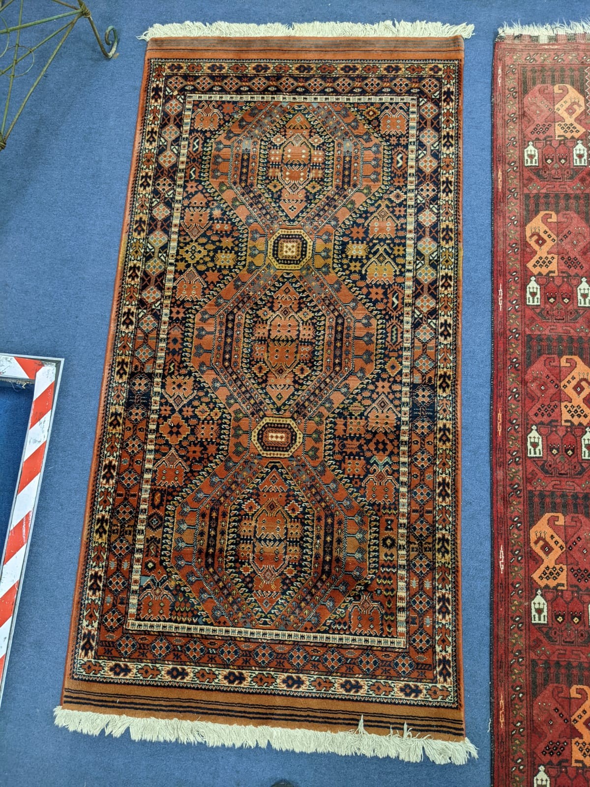 A Bokhara red ground rug, 180 x 126cm and two other rugs